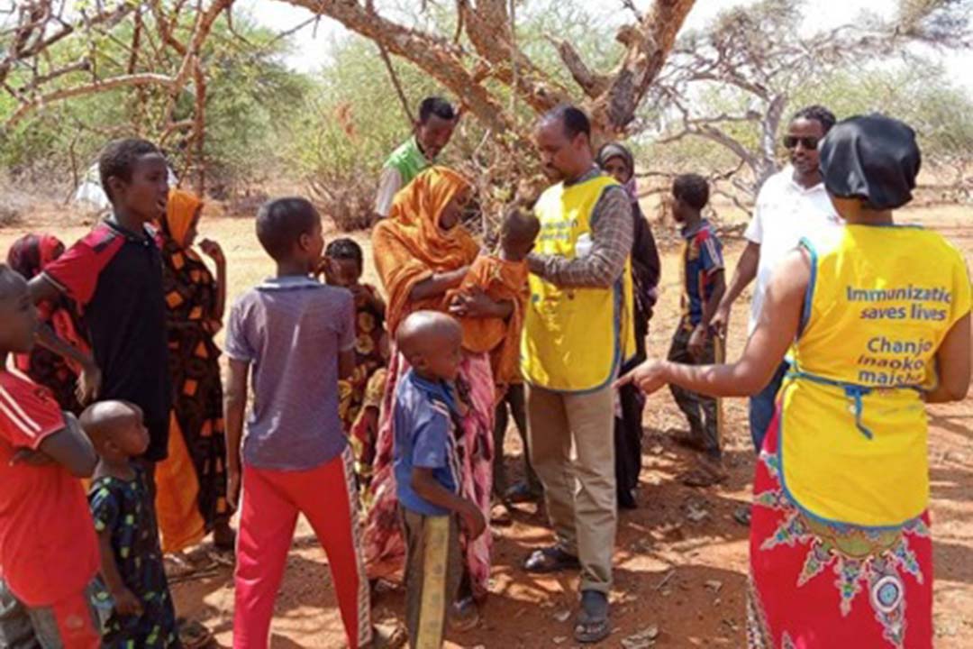 Clinicians Sudani Abdi Awad and Sahra Ali giving the MMR vaccine shot to a child in Banissa Constituency. Credit: Mohamed Ali, Mandera County press.