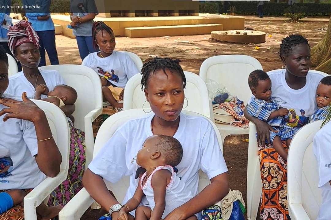 Mothers wait their turn to have their children vaccinated against malaria. Credit: Edna Fleure