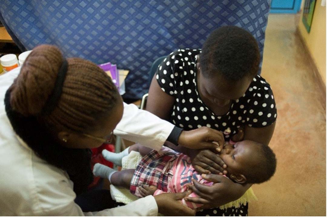 A volunteer clinician gives an infant a dose of a vaccine in Kaptembwa. Credit: Julie Mwabe, CDC Kenya A volunteer clinician gives an infant a dose of a vaccine in Kaptembwa. Credit: Julie Mwabe, CDC Kenya