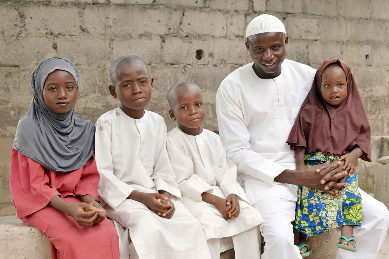 A smiling Yusuf Ibrahim sits with his four children in the tiny farming village of Unguwar Daji in northern Nigeria. The introduction of the pentavalent vaccine in Nigeria is estimated to save the lives of at least 30,000 children who die from vaccine-preventable disorders every year. Nigeria has also introduced the pneumococcal vaccines, which protect against pneumonia, still the world’s biggest killer of children under the age of five. Credit: Gavi/2013/Adrian Brooks.